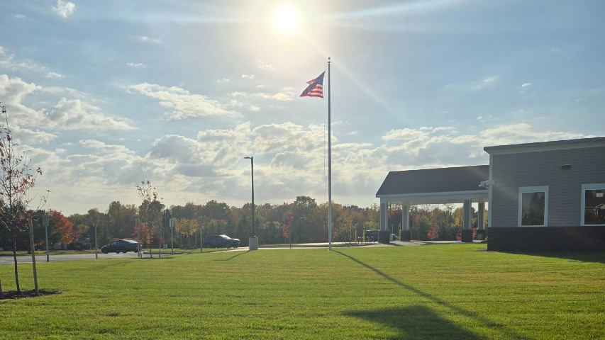 summer commercial landscaping near syracuse ny grass with flagpole